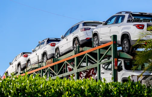 Cegonha com carros na concessionária 